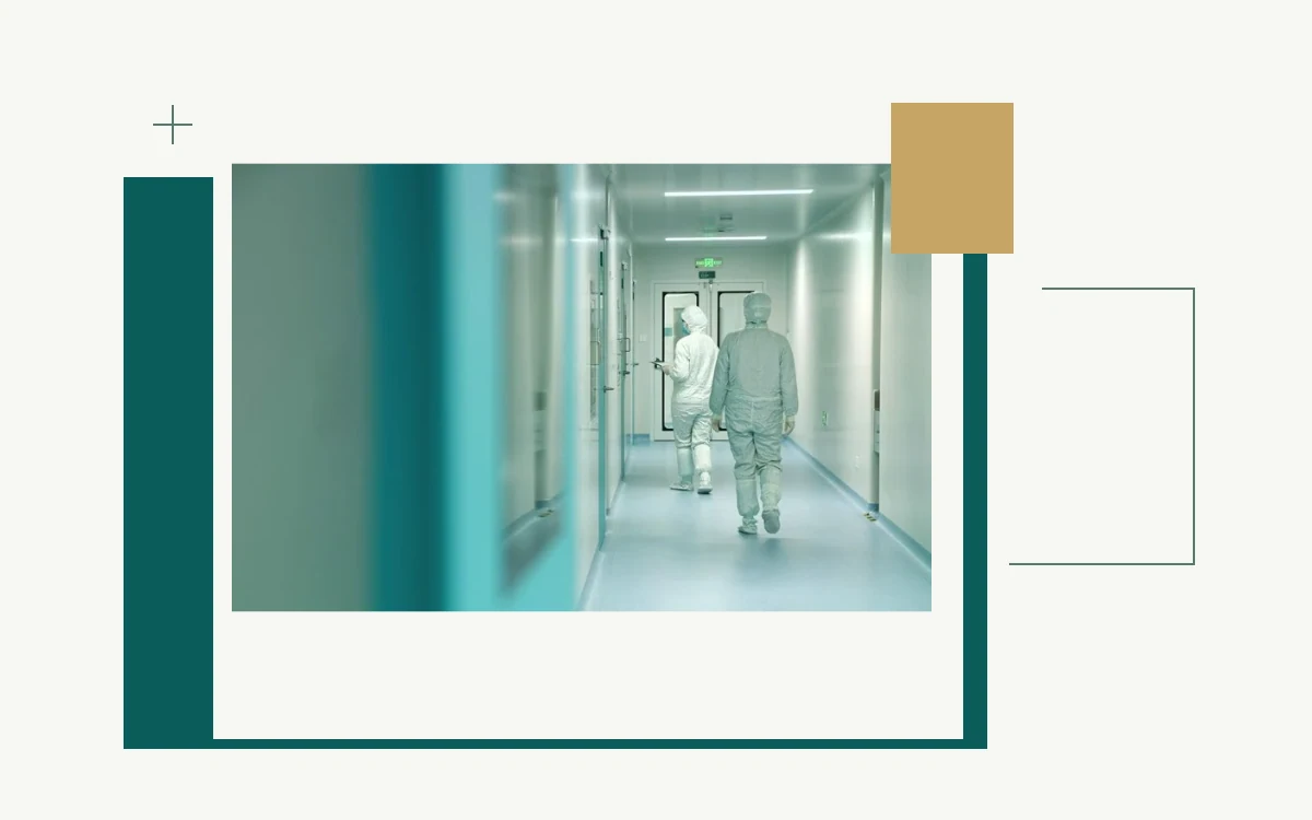 Workers in protective clothing in a Shanghai Cell Therapy Group cleanroom corridor